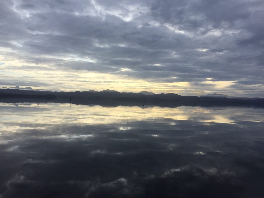 Clouds rolling over still water